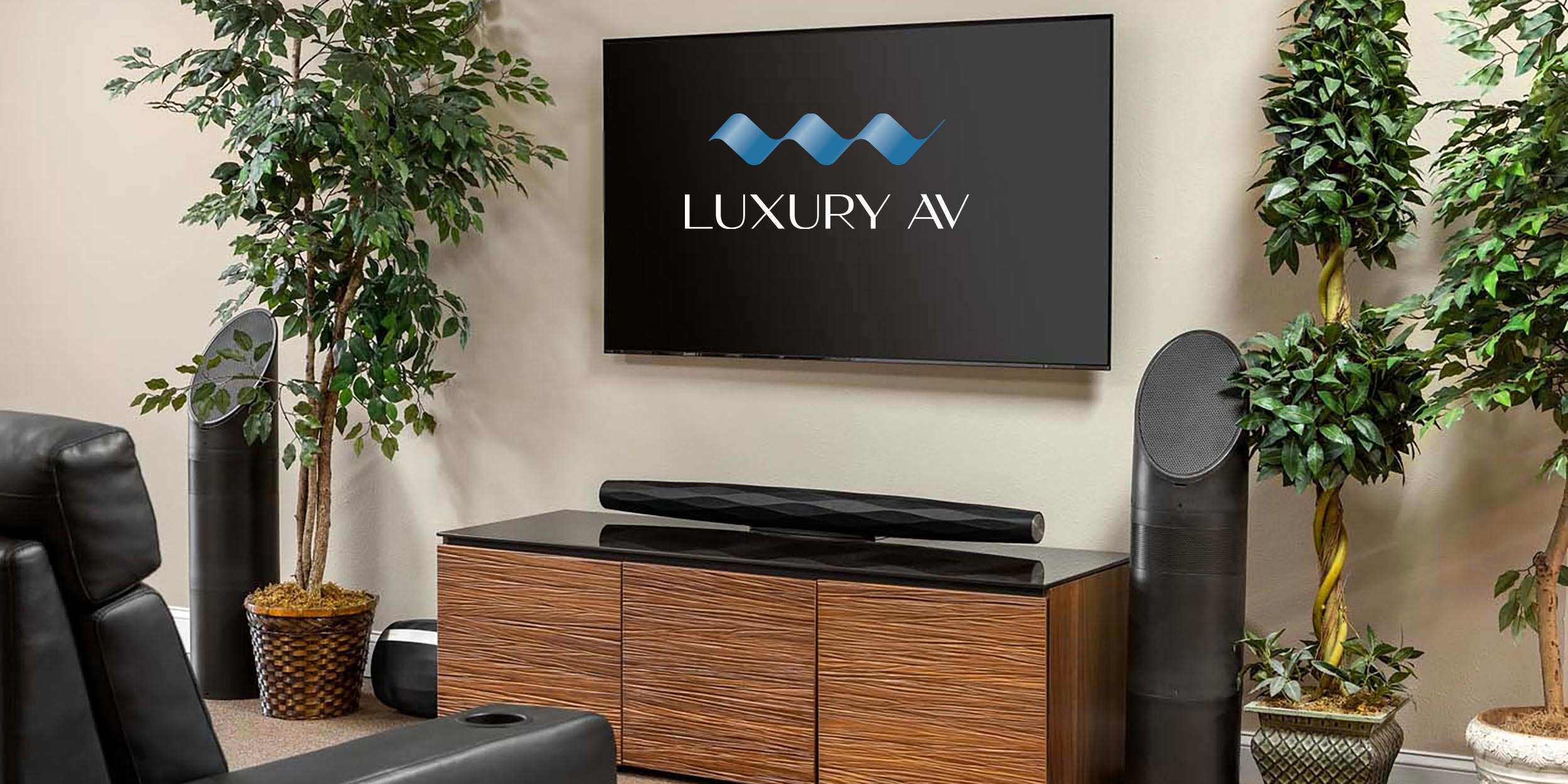 AV showroom with flat-screen TV, sound system, and potted plants