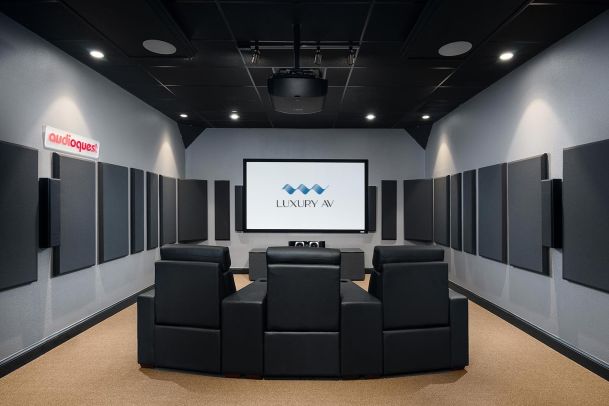 Theater room with projector, black recliners, and Luxury AV screen